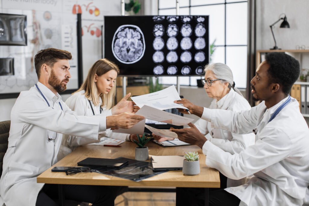 Teamwork of neuroscientists discussing brain disease indoor